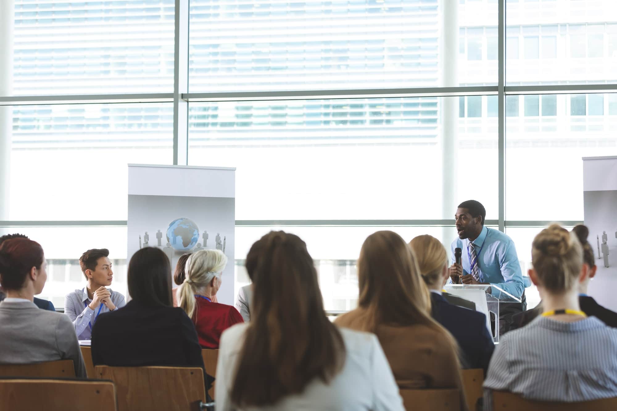Speaking in a business seminar in modern office building